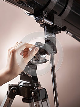 Man adjusts a telescope closeup