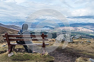 Man admiring landscape view on a bench