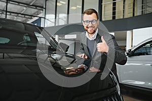 Man adult customer male buyer client wears classic suit white shirt chooses auto wants to buy new automobile touch check