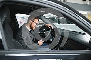 Man adult customer male buyer client wears classic suit white shirt chooses auto wants to buy new automobile touch check