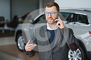 Man adult customer male buyer client wears classic suit white shirt chooses auto wants to buy new automobile touch check