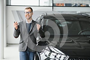 Man adult customer male buyer client wears classic suit white shirt chooses auto wants to buy new automobile touch check