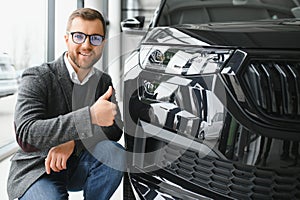 Man adult customer male buyer client wears classic suit white shirt chooses auto wants to buy new automobile touch check