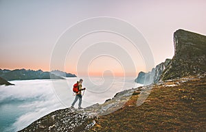 Man adventurer exploring sunset mountains hiking