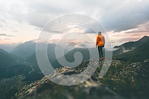 Man adventurer on mountain summit hiking