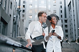 Man with afrian american woman together in the city outdoors