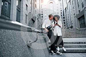 Man with afrian american woman together in the city outdoors