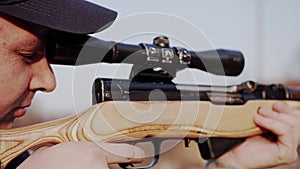 Man aim through the sight of sniper rifle. preparation for a sniper shot.