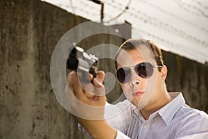 Man aiming a black gun