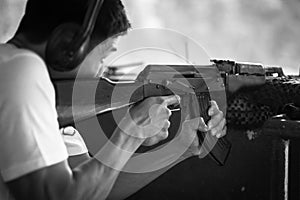 Man aiming a gun at the shooting range, target practicing