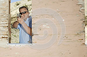 Man Aiming Hand Gun At Firing Range