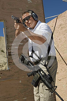 Man Aiming Hand Gun At Firing Range