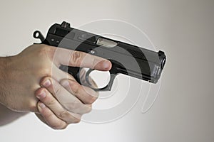 Man aiming Handgun from Holster in Self Defense