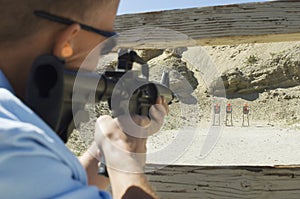 Man Aiming Machine Gun At Firing Range