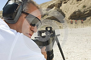 Man Aiming Machine Gun At Firing Range