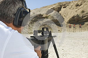 Man Aiming Machine Gun At Firing Range