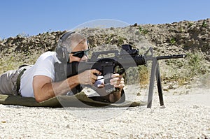 Man Aiming Machine Gun At Firing Range