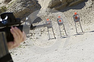 Man Aiming Machine Gun At Firing Range photo