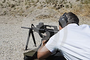 Man Aiming Machine Gun At Firing Range
