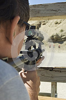 Man Aiming Rifle At Firing Range