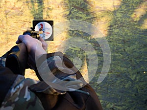 A man aims an air rifl