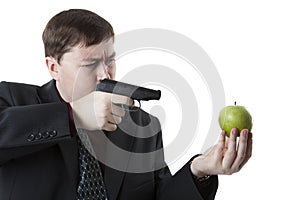 Man aims at the apple on his hand