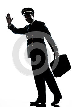Man in airline pilot uniform silhouette walking
