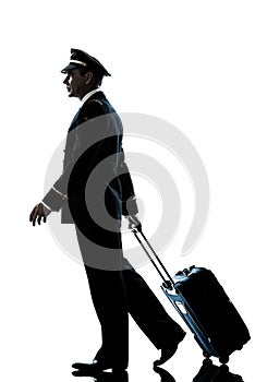 Man in airline pilot uniform silhouette walking
