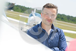 Man with airplane in background