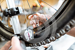 Man aligning bicycle wheel