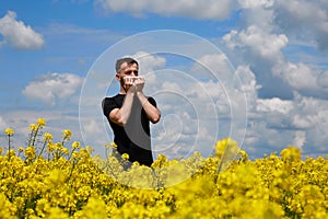 The man is allergic to pollen from blooming plants. Sneezes, covering his mouth with a napkin