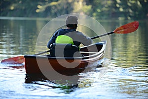 Man alone on a beautiful lake on a kayak