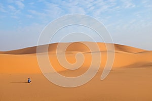 A man alone in a vast desert landscape