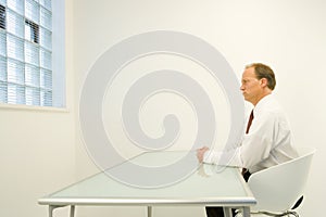 Man alone in white room