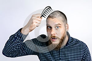 Man with alopecia on head combing hair, Spot Baldness, Hair fall problem