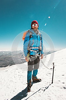 Man alpinist climbing in mountains glacier