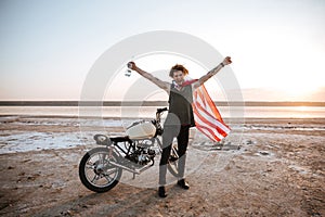 Man in american flag cape with hands up in air