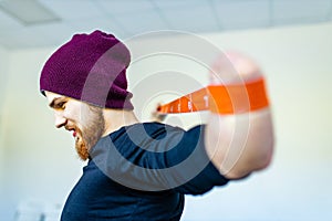 man with amputee hand training with elastic band in gym