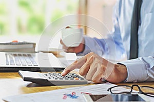 Man Analysis Business Accounting with hands pressing calculator