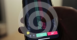 Man analyst using mobile phone app and computer. Analytics for cryptocurrency financial stock market. Trader at the