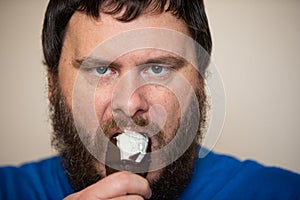 Man angrily protecting his ice cream he is eating