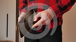 Man angry because of lack of money. Close up of male's hands showing empty leather wallet with no money. Finance business