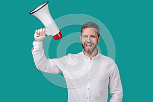 man announce with loudspeaker isolated on blue background. man hold loudspeaker