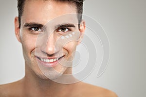 Man with anti- aging cream