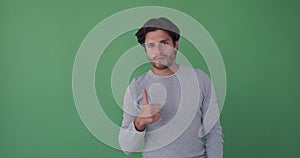 Man appearing giving thumbs up and disappearing on green background