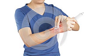 Man apply painkillers to wrist