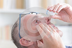 Man applying eye drops