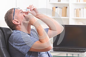 Man applying eye drops