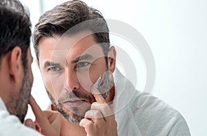 Man applying face cream. Beauty routine. Man with perfect skin. Anti-aging and wrinkle cream. Concept of male beauty