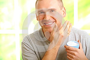 Man applying facial cream